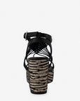 Sandalia de cuña con textil y piel en color negro para mujer