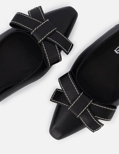 Zapatilla destalonada de piel para mujer color negro con moño decorativo al frente