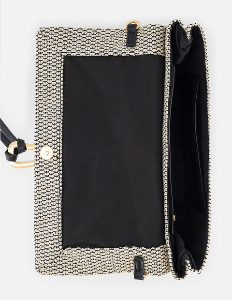 Clutch negro y blanco en rafia tejida con herraje decorativo para mujer