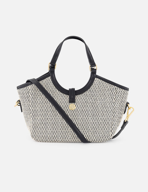 Bolso de mano negro y blanco en rafia con aro metálico