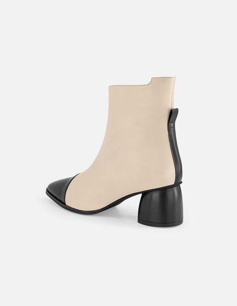 Botines blancos piel de mujer con punta y tacón negros