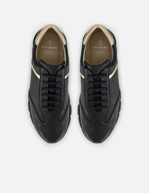 Tenis negro con ribete colro dorado en piel para hombre