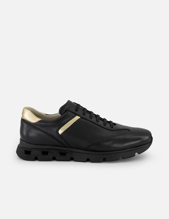 Tenis negro con ribete colro dorado en piel para hombre
